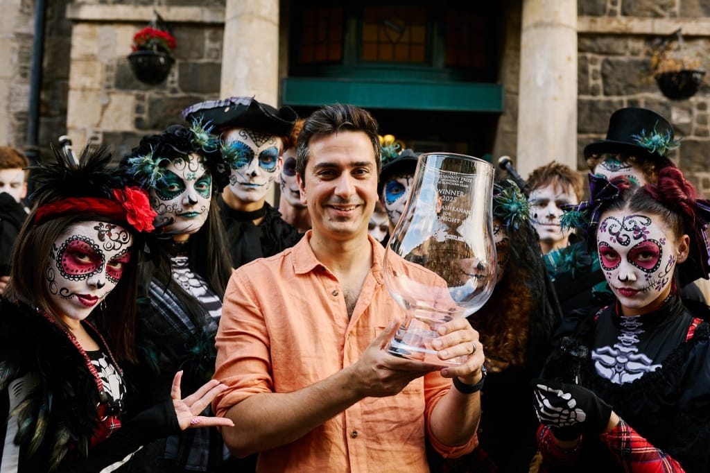 Tariq Ashkanani with performers from Rubber Chicken Theatre and the McIlvanney Prize trophy