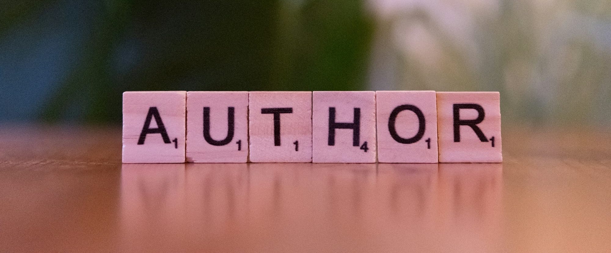 A scrabble type block spelling the word author