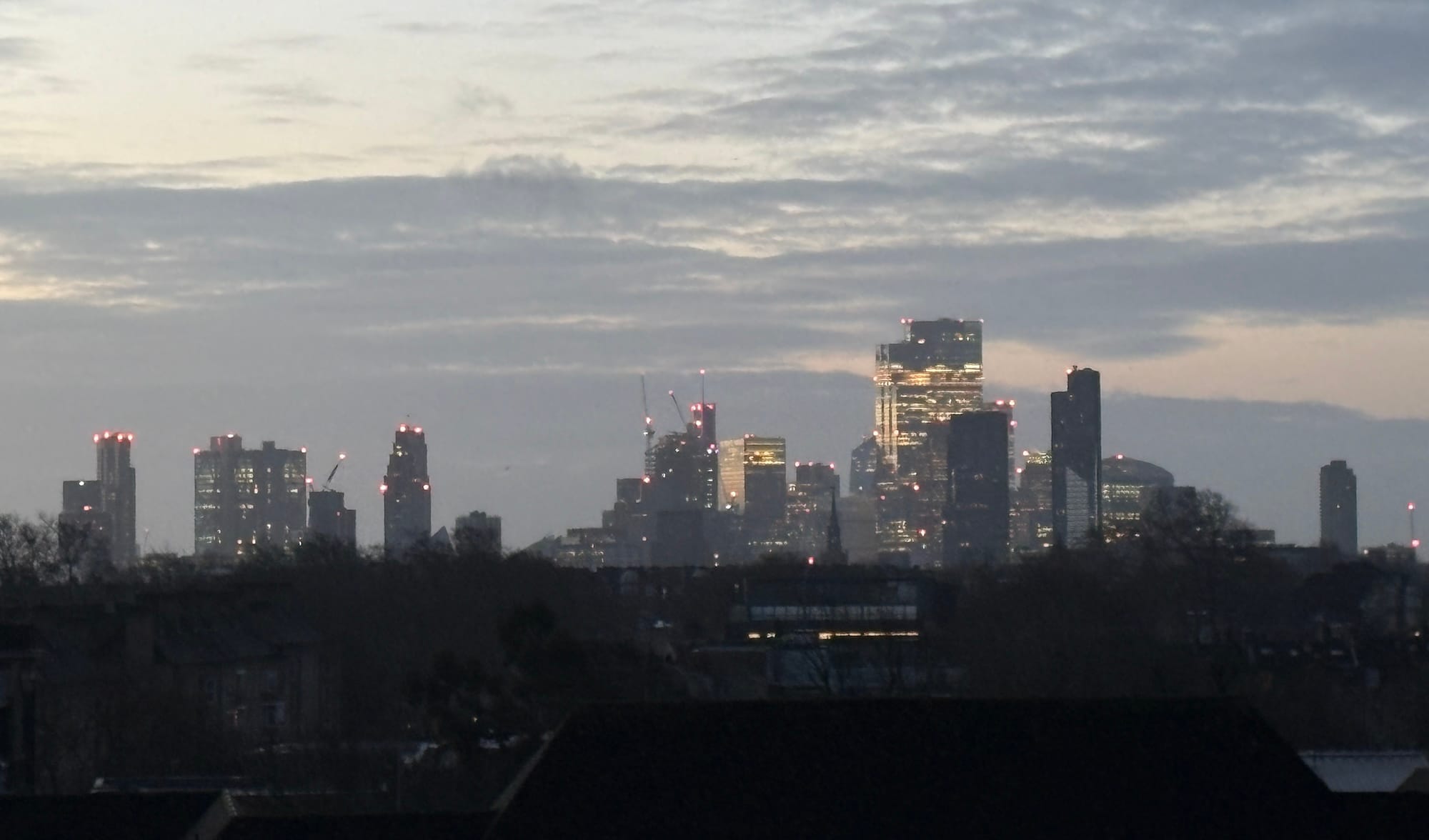 The skyline of London, with City towers visible against the dawn