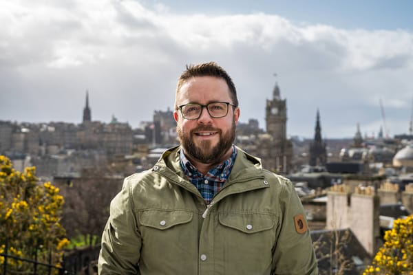 Me, standing in front of the Edinburgh skyline